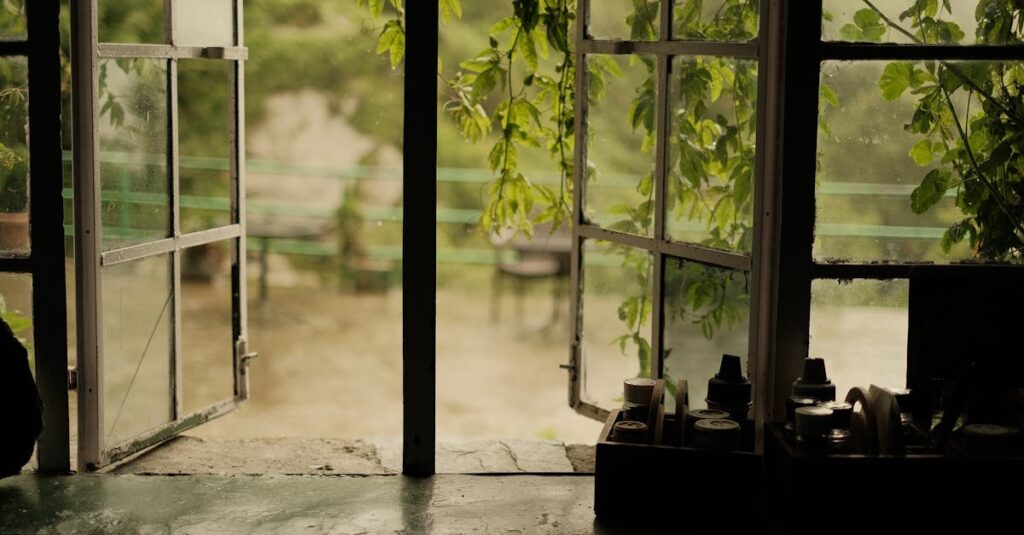 A serene view through an open window with lush green plants cascading outside, creating a peaceful ambiance.