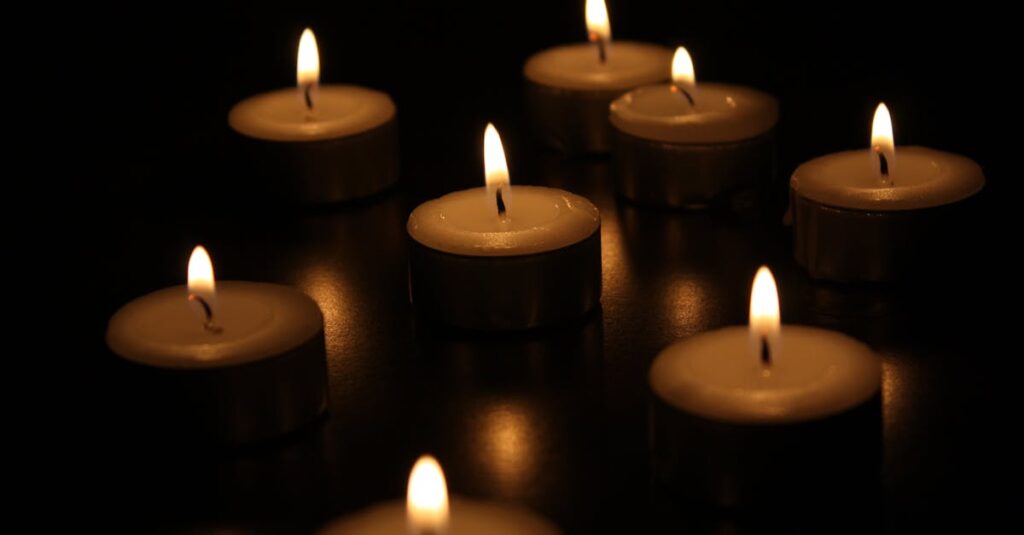 A serene arrangement of burning candles casting a warm glow in the dark.