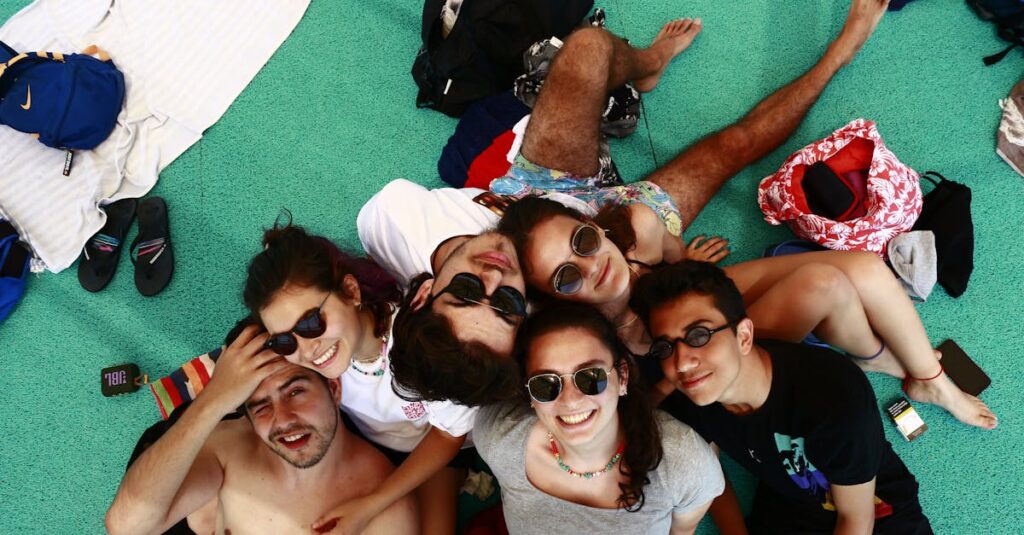 Group of friends enjoying a sunny day together, smiling and relaxed.